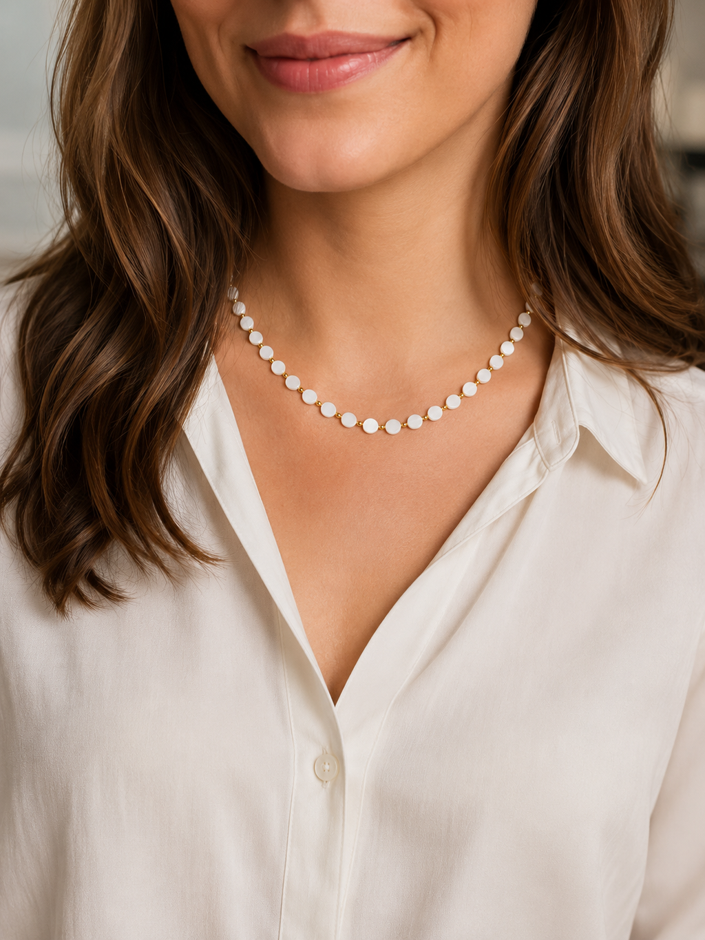 Collier Mahina en pastilles de nacre et hématites dorées porté par un modèle